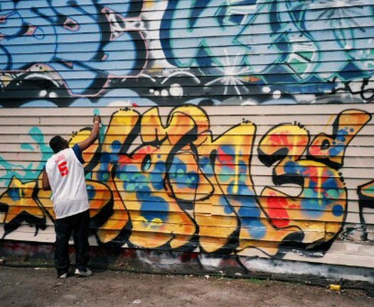 An image showing graffiti artist, Chain 3, at work
